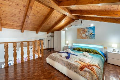 a bedroom with a large bed and wooden ceilings at Casa Ornella in Nebida