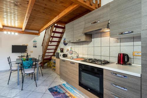 a kitchen with a table and a stove top oven at Casa Ornella in Nebida