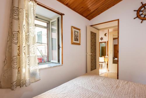 a bedroom with a bed and a window at La Casetta Della Rocca Cefalù in Cefalù