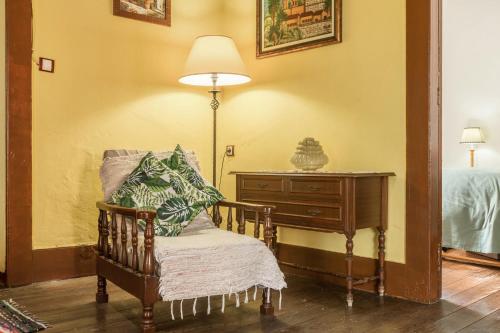 a room with a chair and a lamp and a dresser at Casa Pollo Buen Lugar in Casablanca