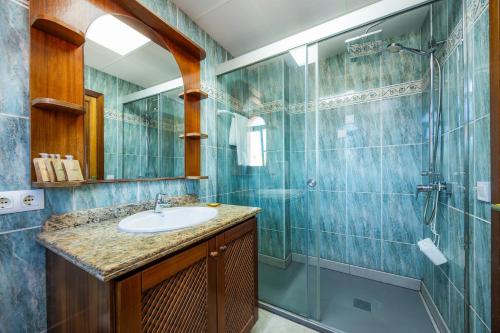 a bathroom with a sink and a shower at Sa Torre iii in Canyamel