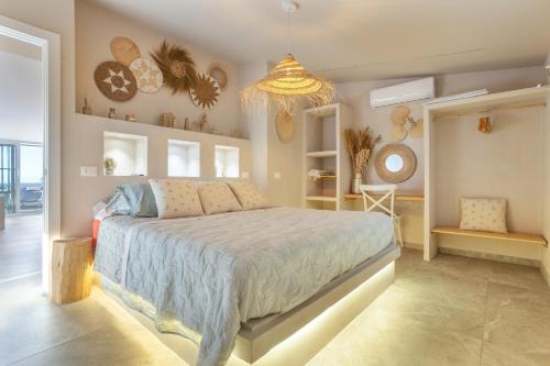 a bedroom with a large bed and a chandelier at Oceania Villa Private Pool Garden in Chayofa