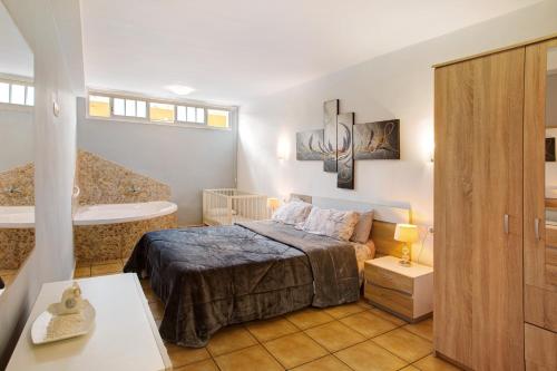 a bedroom with a bed and a bath tub at Montemar 1 in Moya