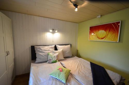 a small bedroom with a bed with pillows on it at Fewo Heym in Suhl
