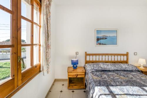 a bedroom with a bed and a window at Villa La Flor con piscina in L'Escala