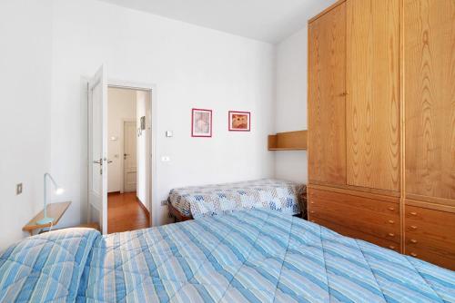 a bedroom with a bed and a dresser in it at Via Colombo 12 Bilo in Bonassola