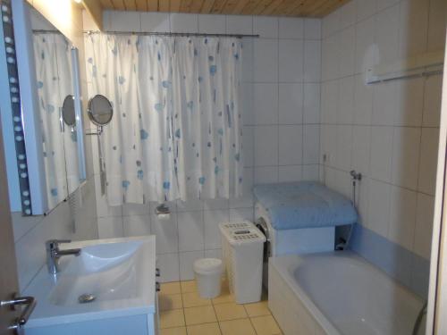 a bathroom with a tub and a sink and a shower at Ferienhof Roller in Simmersfeld