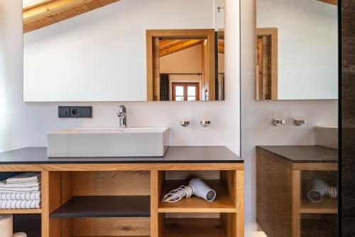 a bathroom with a sink and a mirror at Schreiberhof Charme in Laion
