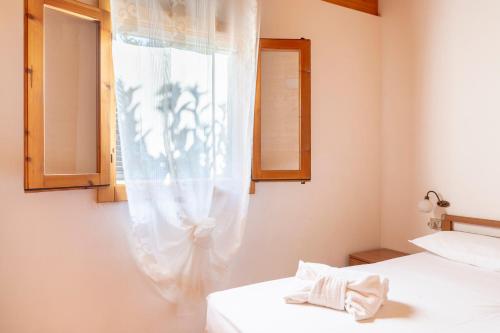 a bedroom with two beds and a window at Agriturismo Alimini a Otranto in Alimini