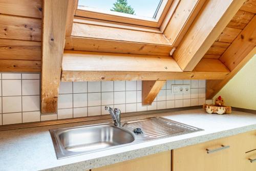 a kitchen with a sink and a window at Beutenmühle Straussenfarm Dach in Owingen