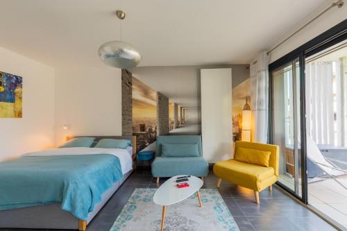 a bedroom with a bed and a table and chairs at Grand studio bord du lac in Saint-Jorioz