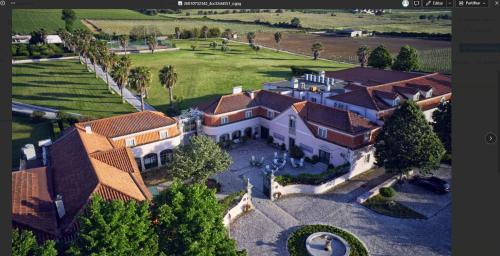 an aerial view of a large house with a yard at Turim Club Azeitao Hotel in Setúbal