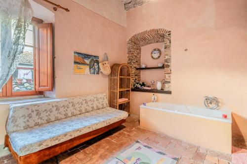 a large bathroom with a tub and a window at Villa Gabriella - Piazzano in Lucca