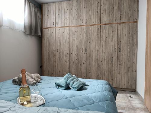 a bedroom with a bed with a bottle of wine at Thea Home Rhodes Pastida in Pastida