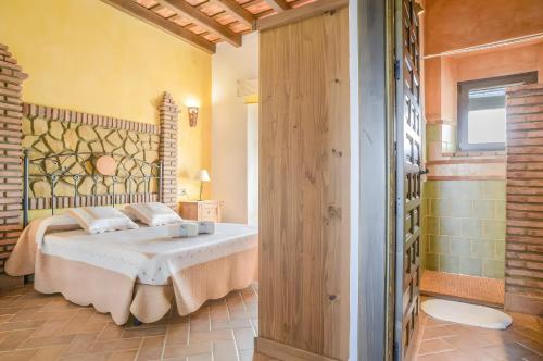a bedroom with a bed in a room at Cartuja Rural in Barbate