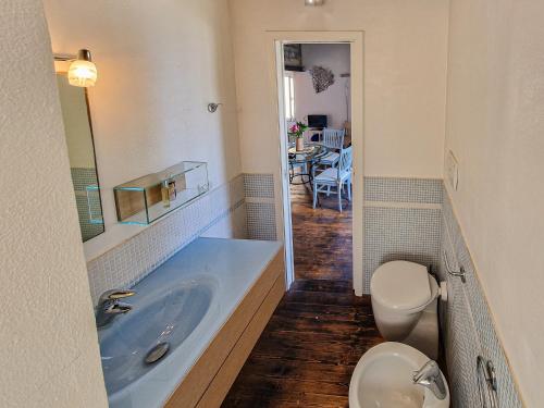 a bathroom with a tub and a toilet and a sink at Loft il Mare Rio Marina front sea in Rio Marina