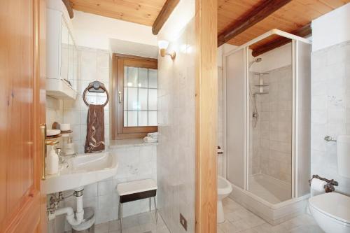 a bathroom with a sink and a toilet and a shower at Maison Tillier Valtournenche in Valtournenche