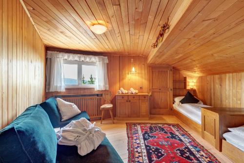 a living room with a couch and a bed at Chalet Magdalena und Lodges in Avelengo