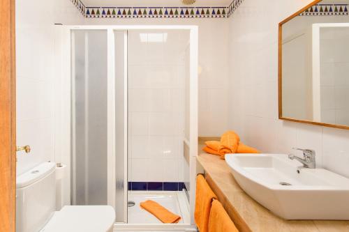 a white bathroom with a sink and a mirror at Luis iii in Puerto del Carmen