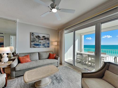 a living room with a couch and a view of the ocean at Regency Isle #609 in Orange Beach
