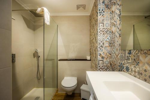 a bathroom with a toilet and a sink and a shower at Apartament Massanet 1b in Canyamel