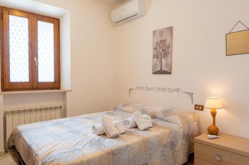 a bedroom with a bed with two pillows on it at Casa Isidora in Acquaviva