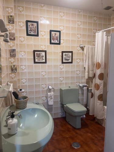 a bathroom with a green toilet and a sink at Villa Neli Playa in Foz