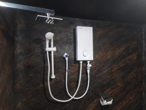 a couple of electrical devices on a wooden floor at Thotupala Eco Lodge in Nilweligama