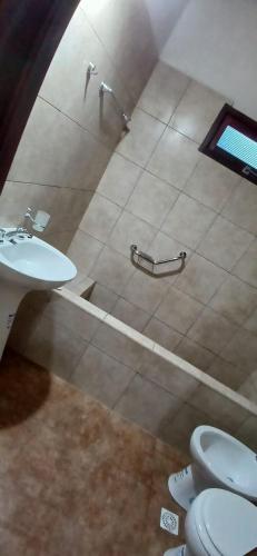 ein Badezimmer mit Toilette und Waschbecken in der Unterkunft Cabañas Termas in Termas de Río Hondo