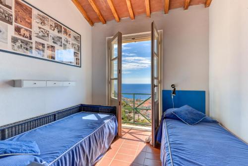 two beds in a room with a view of the ocean at Casa Ebaté in Chiessi