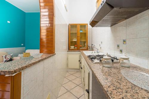 a kitchen with two sinks and a stove at Ciuri Ciuri in Avola