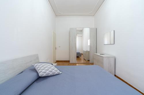 a bedroom with a blue bed in a white room at Ciuri Ciuri in Avola