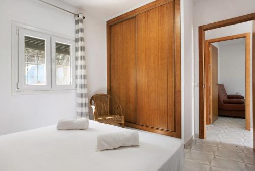 a bedroom with two beds and a wooden door at Villa Montenmedio 2 in El Soto
