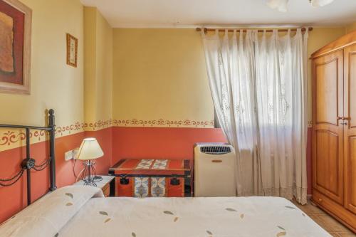 a bedroom with two beds and a window at El Tejado in Maluenda