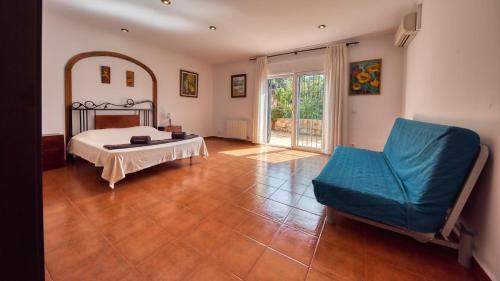 a large room with a bed and a chair at Costacabana - Villa Alba in Lloret de Mar