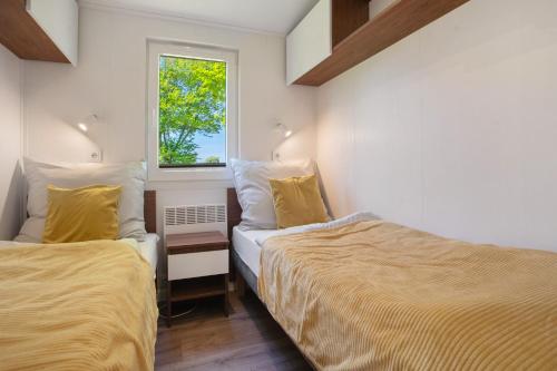 a bedroom with two beds and a window at Haus Waldblick in Saal