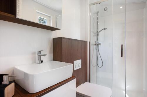 a bathroom with a white sink and a shower at Haus Waldblick in Saal