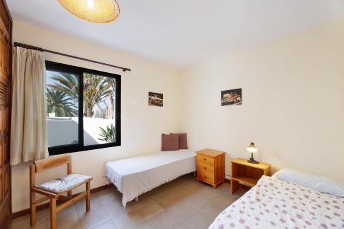 a bedroom with two beds and a window at Moijama 4 in Los Llanos de Aridane