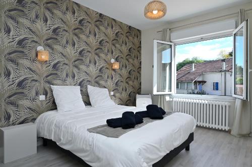 a bedroom with a large bed with a large window at Villa Milady 2 in Salies-du-Salat