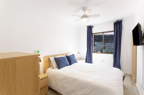 a bedroom with a bed and a window at Casa Neale in Puerto Rico de Gran Canaria