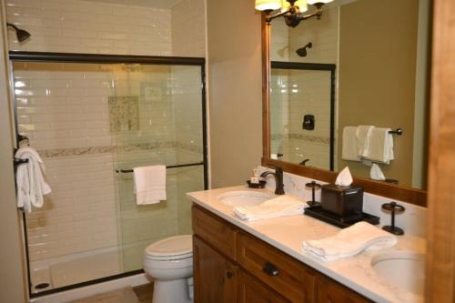 a bathroom with a toilet and a sink and a shower at 81 Meadow Lane in Sunriver