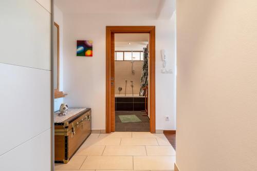 a hallway with a bathroom with a shower and a sink at Gunzhof in Kastelruth