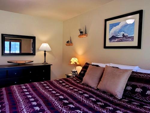 a bedroom with a large bed and a mirror at 89 Meadow House in Sunriver