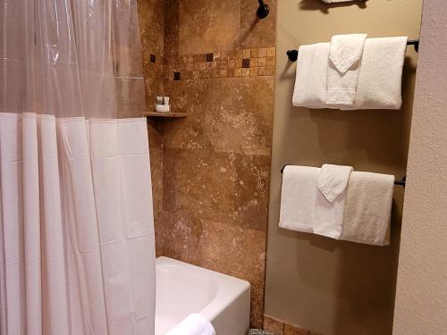 a bathroom with a shower and a toilet and towels at 89 Meadow House in Sunriver