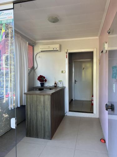 a bathroom with a sink and a shower in a room at Pousada Centro in Gramado