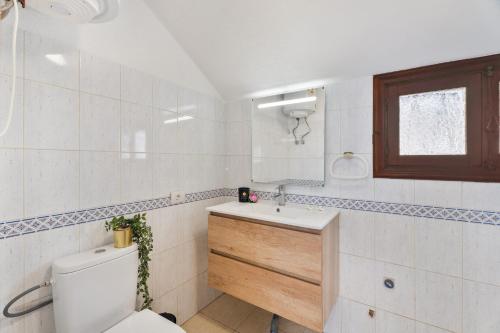 a bathroom with a toilet and a sink and a mirror at Santiago Beach in Costa Adeje