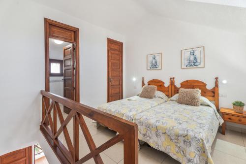 a bedroom with a bed and a wooden bed frame at Santiago Beach in Costa Adeje