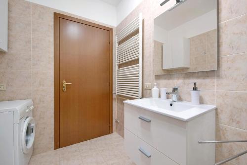 a bathroom with a sink and a toilet and a mirror at vista lago apartment 2 in Soiano del Lago