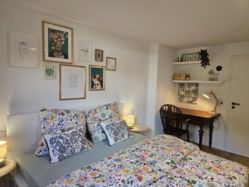 a bedroom with a bed with pillows and a desk at Haus Alb-Apfel in Apfelstetten