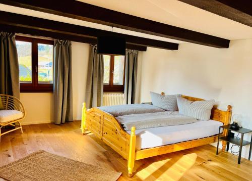 a living room with a bed and a window at Hof Wälderblick in Ibach